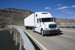 White Semi driving the bridge